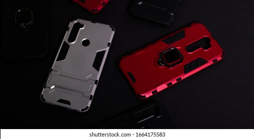 Armor Case For Phone. Strong Plastic Case To Protect Your Phone. Plastic Cases On Black Background.