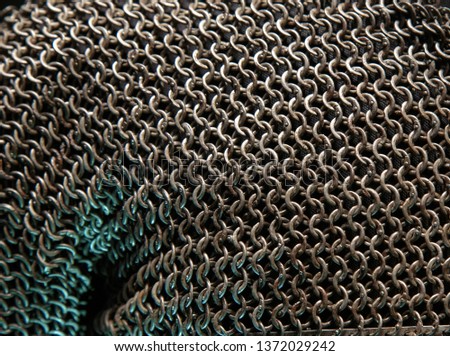 Armor Chain texture. Ring or chain steel mail armour background. Rows of chain mail rings as a texture. metallic silver hauberk from whole rings on a black background close up