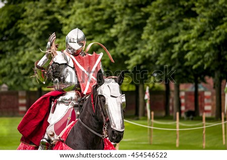 Armored knight suited for battle on horseback, charging in gallop. Galloping it the fastest gait of a horse, and because of the speed the warrior looks even more impressive