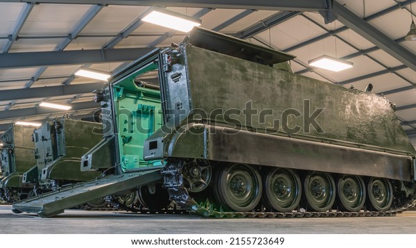 Armored personnel carrier.\
The rear ramp of the armored personnel carrier for boarding and.\
The tracked old tank has been discontinued. Outdated armament of\
the army.
