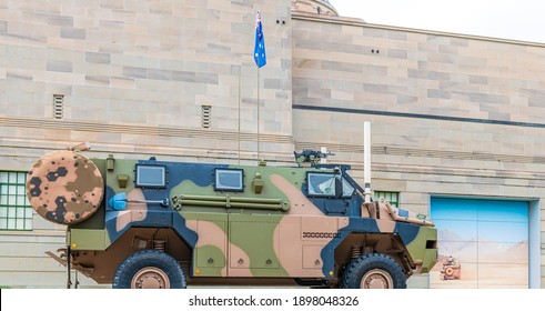 An armour vehicle known as a Bushmaster is parked in the street.