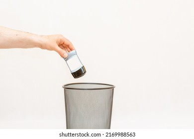 The armpit antiperspirant is thrown into the trash,can for disposal and recycling.White,gray background,selective focus,copy space.