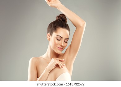 Armpit epilation, lacer hair removal. Young woman holding her arms up and showing clean underarms, depilation  smooth clear skin .Beauty portrait. - Shutterstock ID 1613732572