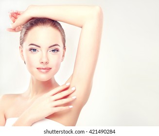 Armpit epilation, lacer hair removal. Young woman holding her arms up and showing clean underarms, depilation  smooth clear skin .Beauty portrait. - Shutterstock ID 421490284