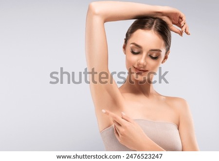 Armpit epilation, lacer hair removal. Young woman holding her arms up and showing clean underarms, depilation smooth clear skin .Beauty cosmetology portrait.