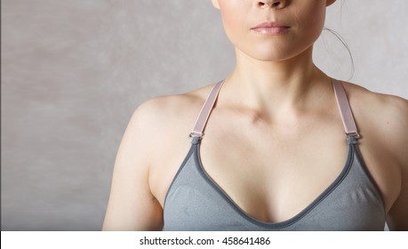 Armpit Fat At Young Woman Between 30 And 40 Years Old Dressed In A Sporty Gray Bra.