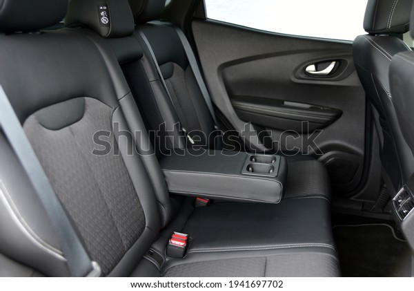 Armrest in\
the car with cup holder for rear seats\
row