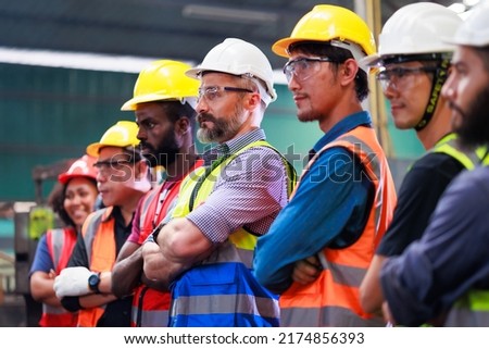 Arms crossed. Professional team working at workplace. Unity and teamwork concept. Portrait engineer factory manager worker and mechanic team together in factory workplace