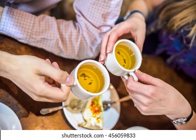 Arms. Man And Woman Drinking Green Tea In A Cafe