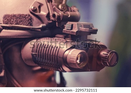 Army binoculars with night vision on a soldier's helmet. Optical device on a military helmet for tracking in war