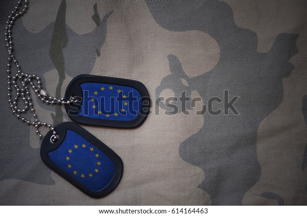 army blank, dog tag with\
flag of european union on the khaki texture background. military\
concept