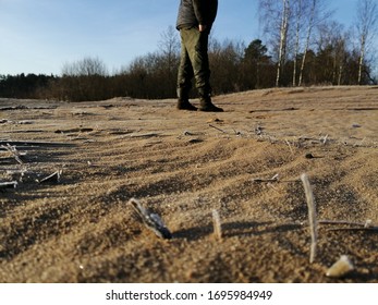 Army Boots On The Frozen Sand By The Lake