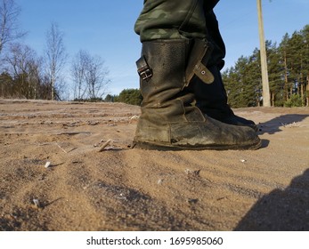 Army Boots On The Frozen Sand By The Lake