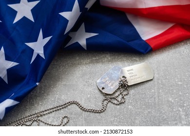 Army Dog Tag Token With 9mm Bullets And Pistol Lie On Folded United States Flag