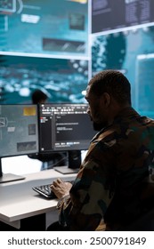 Army intelligence expert utilizes modern computer systems and satellite radar imagery to enhance national security, support strategic initiatives and ensure defense in a mission control center.