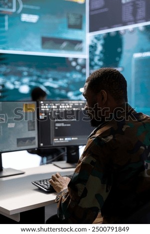 Army intelligence expert utilizes modern computer systems and satellite radar imagery to enhance national security, support strategic initiatives and ensure defense in a mission control center.