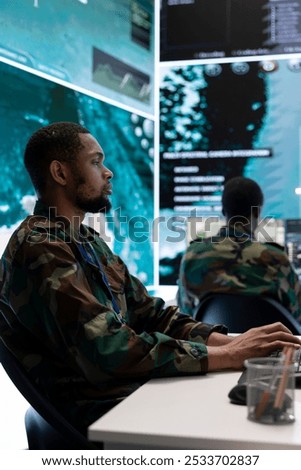 Army intelligence specialists utilize advanced computer systems, surveillance technology and satellite data to enhance national security. Working in a command post against potential threats.
