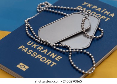 Army medallion, Ukrainian flag, Ukrainian passport. Concept: military service, armed forces, Ukrainian military, war in Ukraine.