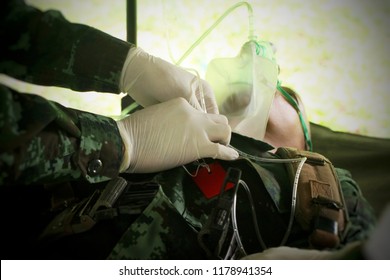 Army Medic Assists Wounded Soldier.