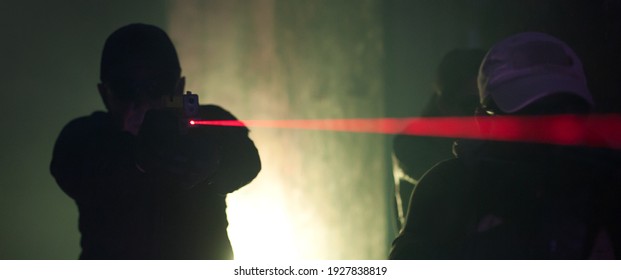 Army Soldier In Action Aiming At Weapon Laser Sight Optics. Shooting And Weapons. Outdoor Shooting Range