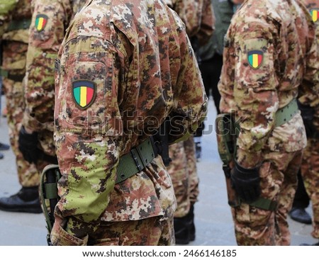 army soldiers wearing camouflage uniform and national flag insignia