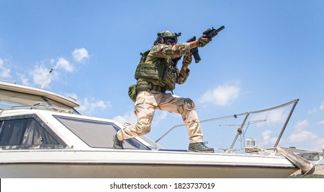 Army Special Forces Soldier, Commando Fighter In Full Ammunition, Wearing Body Armor And Helmet, Armed Service Rifle, Standing On Bow Of Speed Boat, Looking Into Distance During Seacoast Patrolling