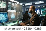 Army specialist employing AI tech to improve military warfare systems and threat monitoring. IT admin uses neural networks to enhance combat operational capabilities, camera B