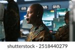 Army telecommunication systems operator using radio gear, providing combat support, doing patriotic duty. African american military dispatcher managing communications networks, camera A