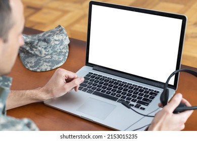 Army. Young Soldier Working With A Laptop Computer With Blank Screen On Black Background.