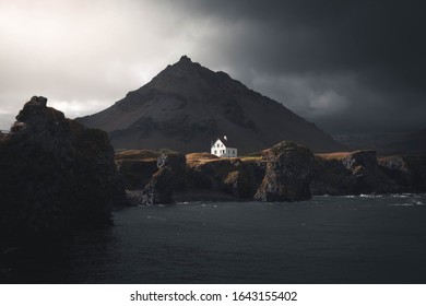 Arnarstapi is a famous village in west of iceland.Very popular tourist destination with beautiful volcanic formations.Snaefellsness peninsula is truly beautiful.isolated,remote house with mountain - Powered by Shutterstock