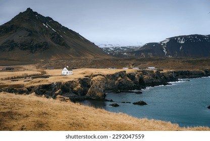 Arnarstapi is a picturesque coastal village located on the Snæfellsnes Peninsula in Iceland. The rugged cliffs and dramatic rock formations, such as the famous Gatklettur arch, make for stunning photo - Powered by Shutterstock - Get 15% off with code: PIKWIZARD15
