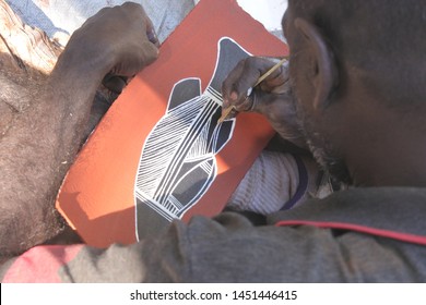 ARNHEM LAND, NT - JULY 08 2019:Aboriginal Artist Dot Painting. Aboriginal Artists Eliminating The Sacred Elements And Abstracting Their Paint Into Dots To Conceal Sacred Designs Which Used In Ceremony