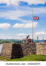 Arnside, Lancashire, UK. May 23rd 2017. Dog Walker Taking A Dangerous Shortcut By Climbing The Wall Of The Pier At Arnside, Lancashire, UK