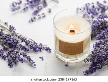 Aroma Candle. Lavender candle on a white tile background. Lavender spa.  - Powered by Shutterstock