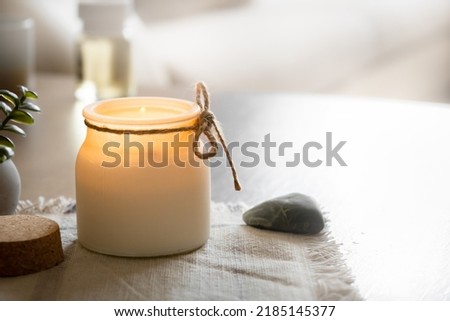 Aroma candle on table in badroom, decor elements, cozy home and relax concept, free space for text