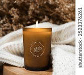 Aroma candle on wooden table. Caramel scented candle in brown glass. Mockup for spa design, packaging mockup.