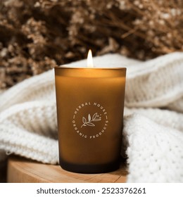 Aroma candle on wooden table. Caramel scented candle in brown glass. Mockup for spa design, packaging mockup.