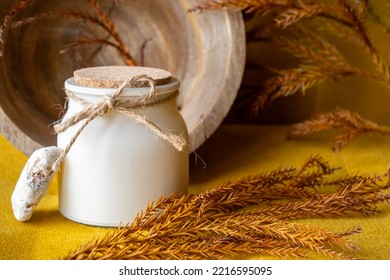 Aroma Candle And Pine Branch On Wooden Table, Cozy Atmosphere At Home, Decor Elements, Autumn Colors