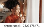 Aroma, coffee and wellness with face of woman in living room of home to relax for weekend. Fresh, scent and smell with happy African person in apartment for morning beverage or caffeine drink