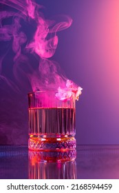 Aroma. Creative Composition With Whisky Glass And Smoke Over Dark Colored Background In Neon Light. Concept Of Art, Decorations, Creativity, Decor. Design For Poster, Greeting Card, Magazine Cover