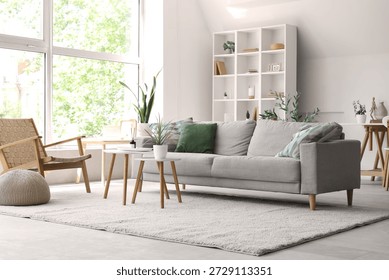 Aroma diffuser on table and sofa in modern light living room