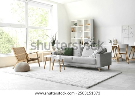 Aroma diffuser on table and sofa in modern light living room
