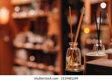 Aroma diffuser wooden sticks in the glass bottle. Cozy home decoration in the interior. Air freshener concept. Aesthetic details. Mock up - Shutterstock ID 2119481249