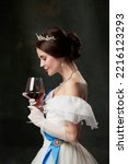 Aroma and flavor. Young elegant woman in image of princess or viscountess tasting red wine isolated on dark vintage background. Comparison of eras concept, fashion, art, ad.