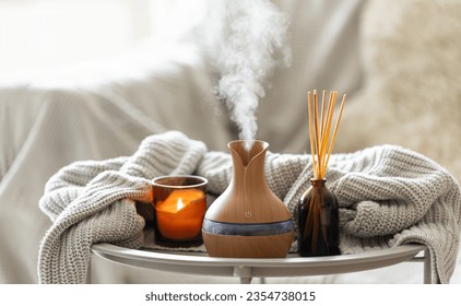 Aroma oil diffuser lamp with the stick perfume, knitted element and candle. - Shutterstock ID 2354738015