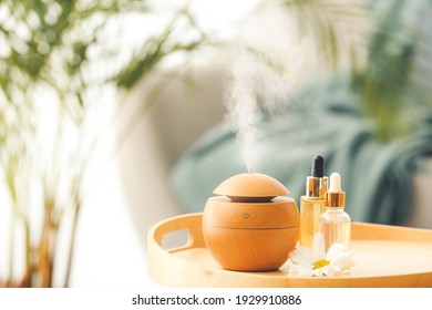 Aroma oil diffuser on table in room - Shutterstock ID 1929910886