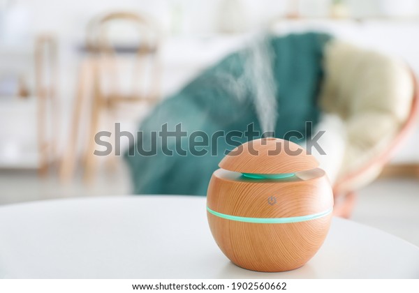 Aroma oil diffuser on table
in room