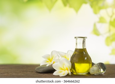 Aroma Oil Massage  With Frangipani Flower And Natural Background. Spa Concept.