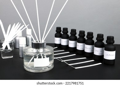 Aroma Reed Diffuser Bottle Is On Black Table With Essential Oil ,frangrance Oil Bottle And Blotter Testing Paperfor Testing Smell During Blending Process For Choosing Nice Scent For Reed Diffuser