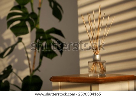 Aroma reed diffuser on table in room. Closeup